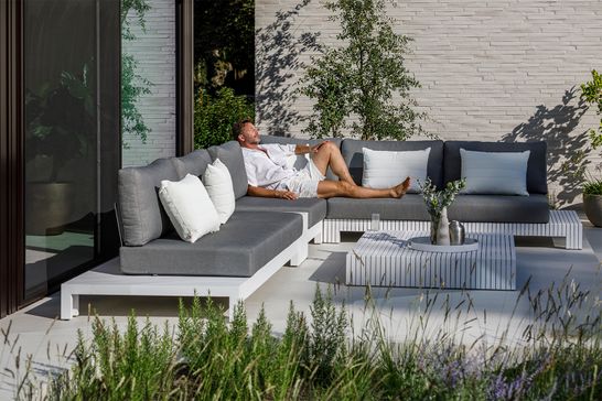 White aluminium lounge with gray outdoor cushions